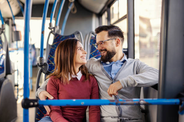 istock Young passenger couple riding public bus and hugging. 2193926199