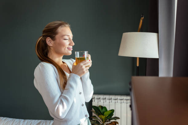 istock Woman peacefully enjoying tea by a window in a comfortable interior setting 2193926681