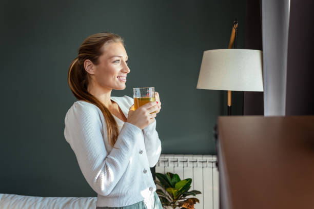 istock Woman peacefully enjoying tea by a window in a comfortable interior setting 2193926701