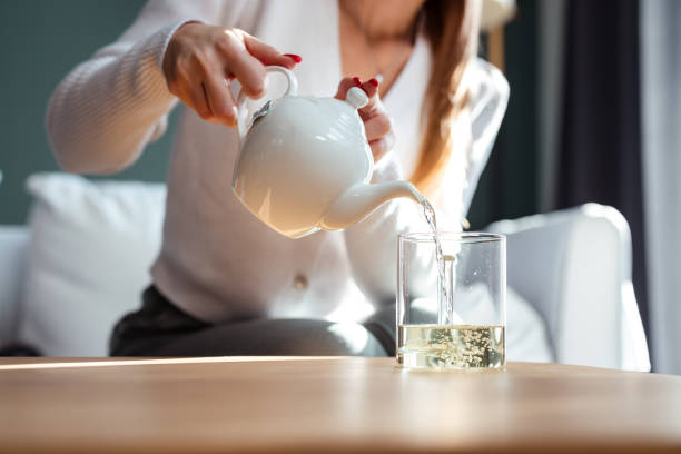 istock Pouring herbal tea into a glass at home 2193927226