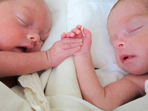istock Newborn Premature Twins holding hands 2193927757