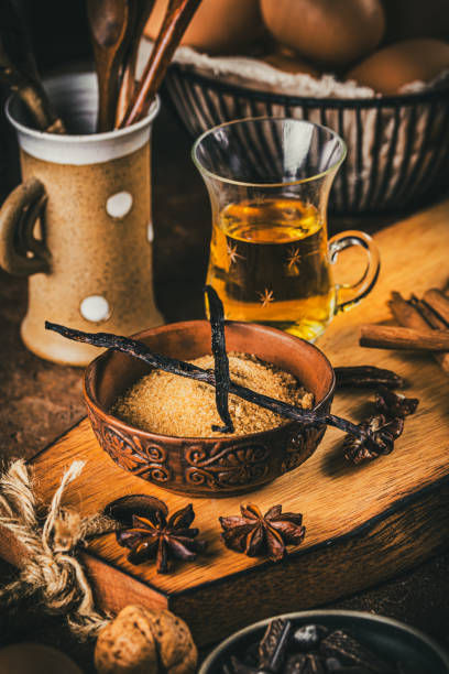 istock Vanilla beans, brown sugar, rum and other baking ingredients on rustic brown background 2193928154