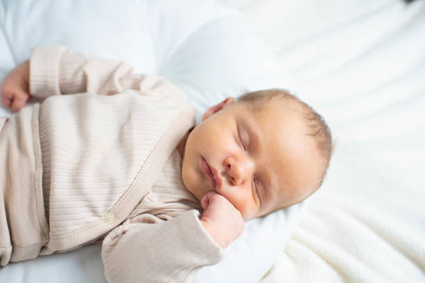 istock newborn baby, 23 days old, sleeping. 2193932186