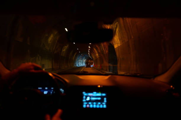 Curve tunnel for automobiles. Empty engineering construction with rhythm of lights and structure. Highway infraestructure.