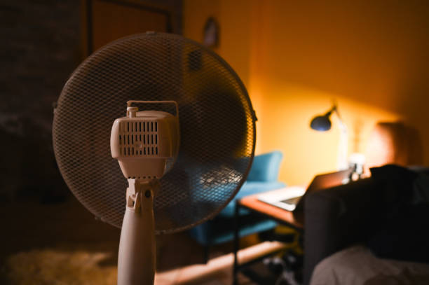 istock fan blowing close up indoors at night. 2193933946