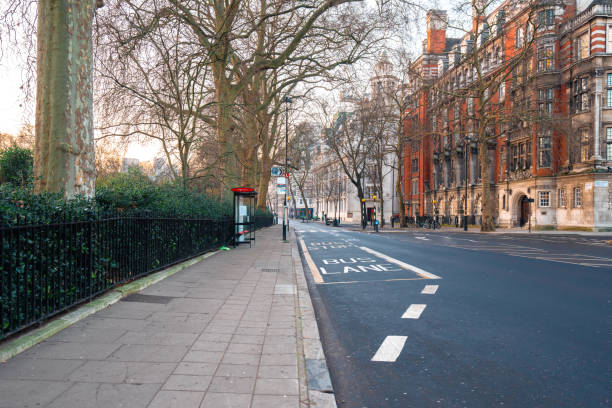 istock Empty bus lane in london with red building and trees 2193937223