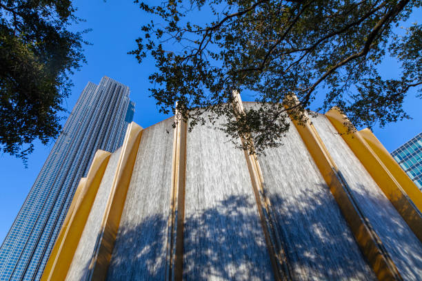 Gerald D. Hines Waterwall Park with skyscrapers in the background, Houston, Texas.
