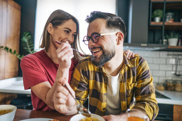 istock A man and a woman have breakfast in the kitchen. 2193938495