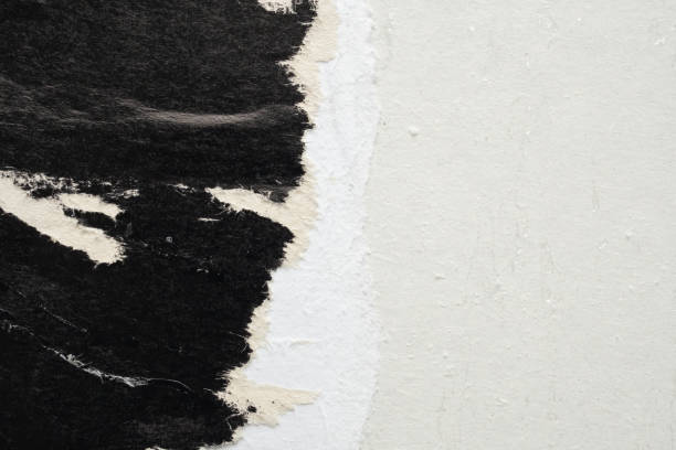 istock Old grunge ripped torn black paper poster surface texture background 2193938881