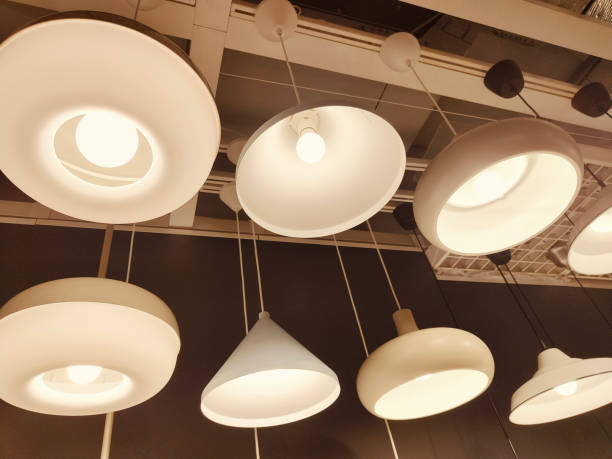 istock A collection of white pendant lights hanging from the ceiling, each light has different shapes and sizes 2193939018