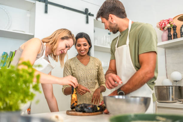 istock Caucasian Couple Learns Cooking Skills from Indian Chef 2193939473
