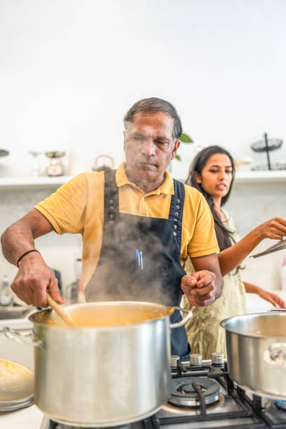 istock Skilled Indian Chef Prepares Dish in Contemporary Kitchen 2193939521