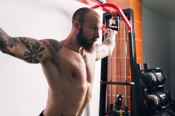 istock concentrated muscular man doing exercise at gym 2193939572