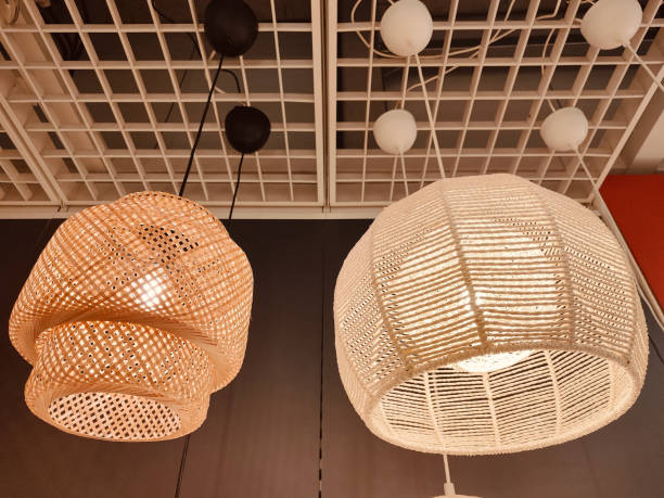istock Two white rattan pendant lamps hang from the ceiling 2193940217