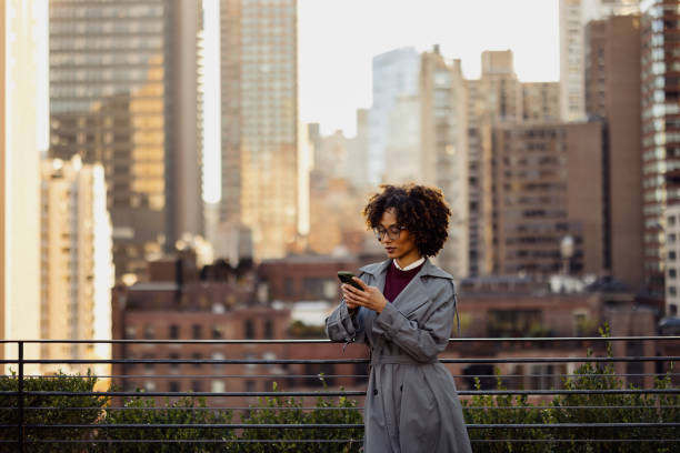Stylish Professional Using Smartphone in Modern Urban City Roof Setting