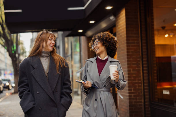 istock Two Friends Sharing a Laugh While Strolling on a City Street 2193941001