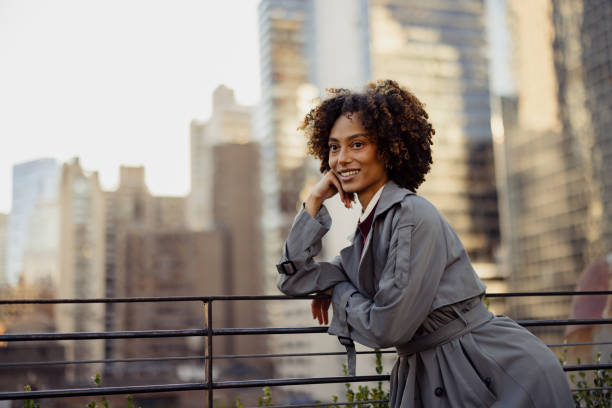 istock Confident Woman Posing Outdoors with Urban Skyline in the Background 2193941009