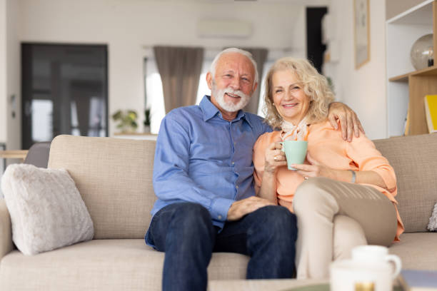 istock Joyful Seniors Embracing Together on a Stylish Sofa 2193941130