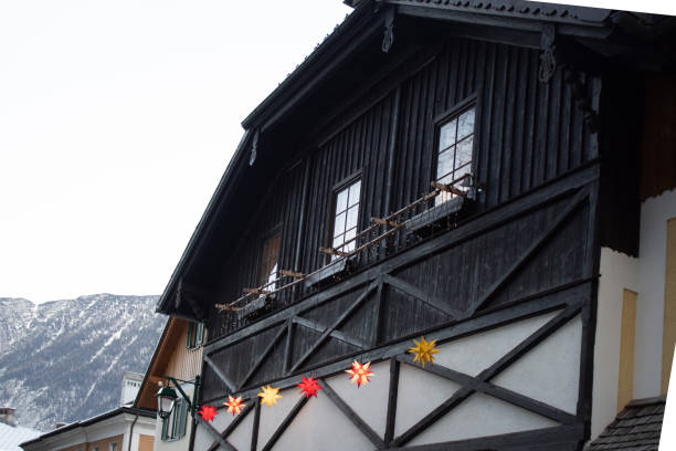 Picturesque view of Hallstatt city and lake, surrounded by stunning alpine mountains and serene waters.
