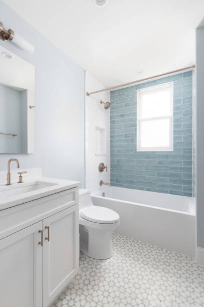 istock A bathroom with blue walls, pattern tile floor, and blue subway tile shower. 2193944111