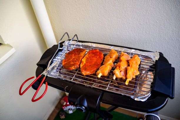 The meat is cooked on an electric grill