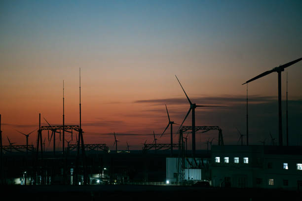 High voltage substation and wind power plant, distant shooting, sunset time
