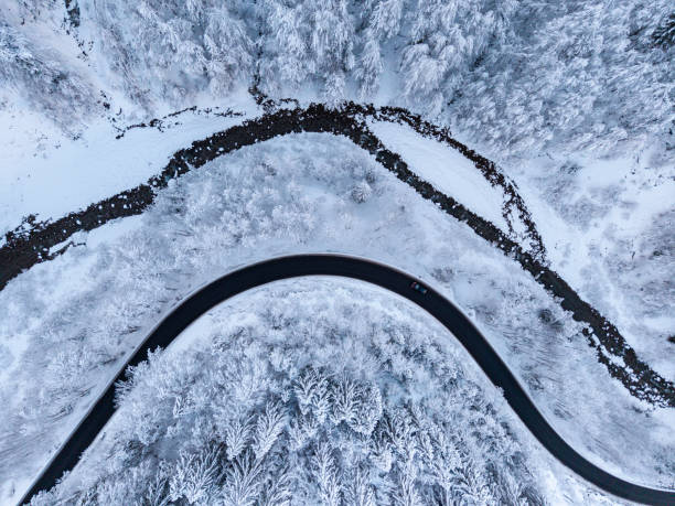 istock Aerial view on winter landscape with a road beside a river 2193948819
