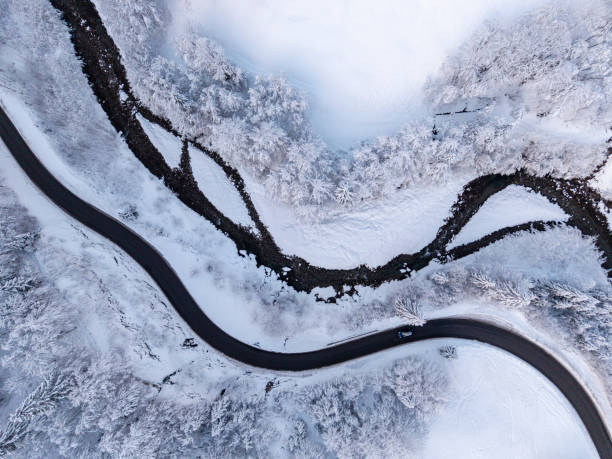 istock Aerial view on winter landscape with a road beside a river 2193948821