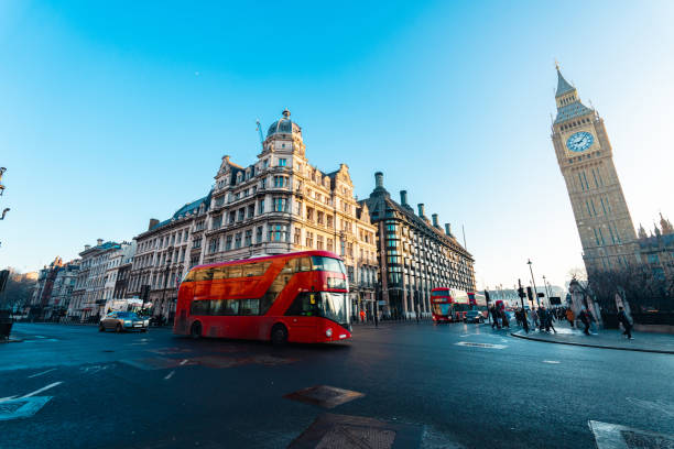 istock Red double-decker bus passing by big ben in london, uk 2193950392