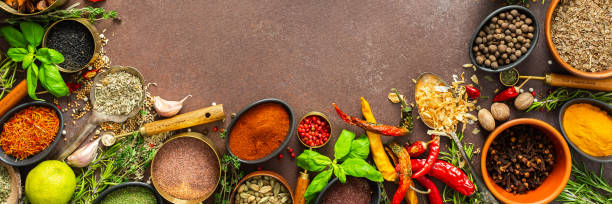 istock A visually striking arrangement of fresh spices and herbs on a brown surface, highlighting their vivid colors, intricate details, and rich culinary essence, banner 2193952383