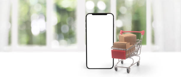 istock smartphone with shopping cart and a box 2193952770