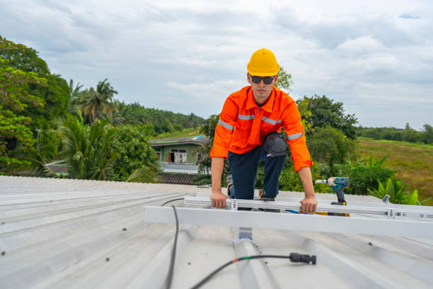 istock Technician in safety uniform and helmet kneeling on a rooftop, using a drill for precise installation work. A scene highlighting safety, professionalism, and technical expertise in construction. 2193953204