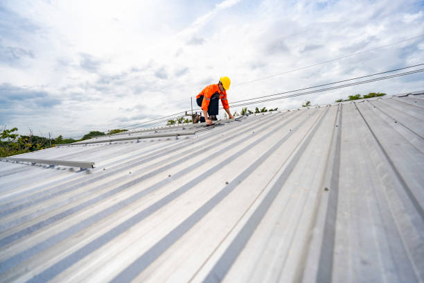 istock Technician in safety uniform and helmet kneeling on a rooftop, using a drill for precise installation work. A scene highlighting safety, professionalism, and technical expertise in construction. 2193954718