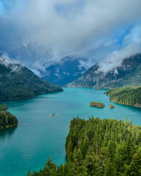 istock Serene Lake Amidst Misty Mountain Peaks 2193955254