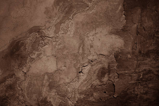 istock Black brown beige concrete wall surface. Grunge texture background. Close-up. Paint. Crack old rough broken damaged crumbled creepy. Dark light. Mocha mousse color 2025. 2193955343