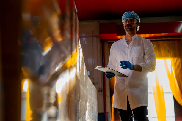 istock Technician inspecting stacked products in a brightly lit warehouse Focus on quality control logistics and industrial efficiency in modern manufacturing settings. 2193955800