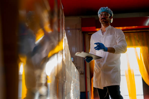istock Technician inspecting stacked products in a brightly lit warehouse Focus on quality control logistics and industrial efficiency in modern manufacturing settings. 2193956350