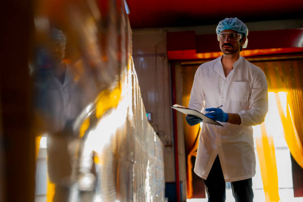 istock Technician inspecting stacked products in a brightly lit warehouse Focus on quality control logistics and industrial efficiency in modern manufacturing settings. 2193956696