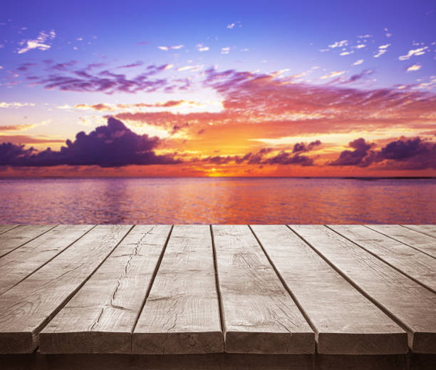 istock Empty wooden table top with tropical ocean sunset background 2193956727