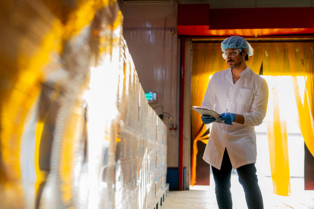 istock Technician inspecting stacked products in a brightly lit warehouse Focus on quality control logistics and industrial efficiency in modern manufacturing settings. 2193957072