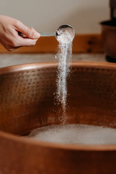 istock Pouring bath salts into a copper tub for a relaxing soak. 2193959883