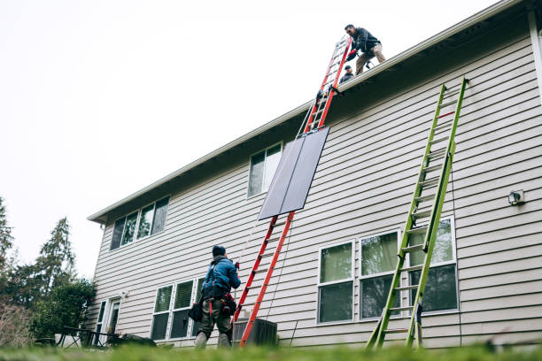 istock Solar Energy Technicians Hoisting Solar Panels To Rooftop 2193961062