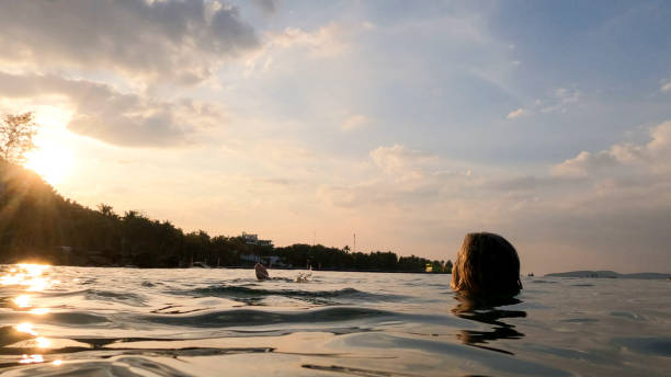 istock Mature woman floats on back in sea 2193965550