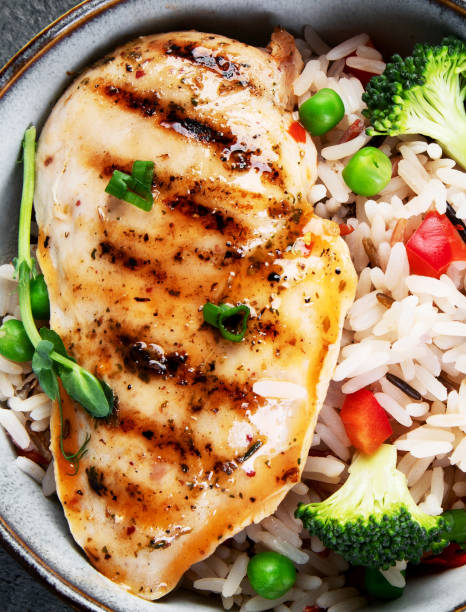 istock Grilled chicken with vegetables and rice. 2193971407