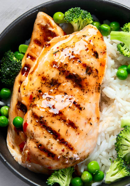 istock Grilled chicken with green vegetables and rice. 2193971510