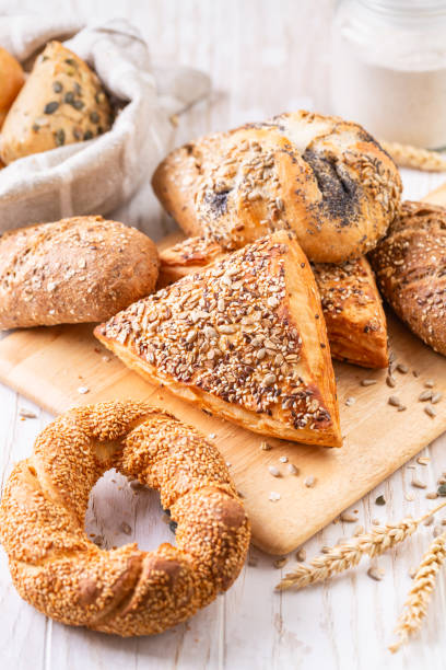 istock Variation of bread rolls or buns with butter and assorted seeds with breadbag 2193973704