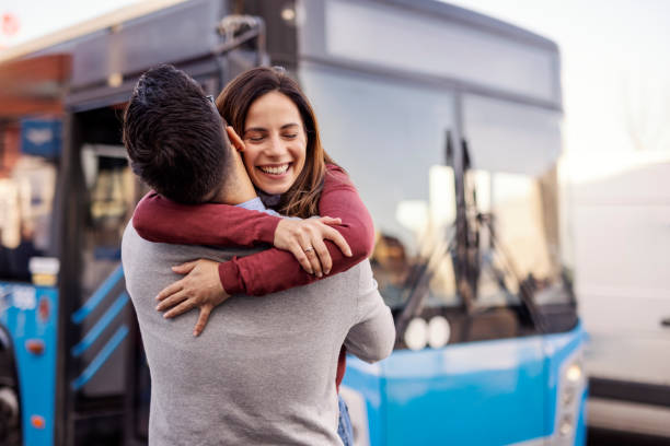 istock Affectionate couple hugging near bus stop with city bus in background. 2193976211