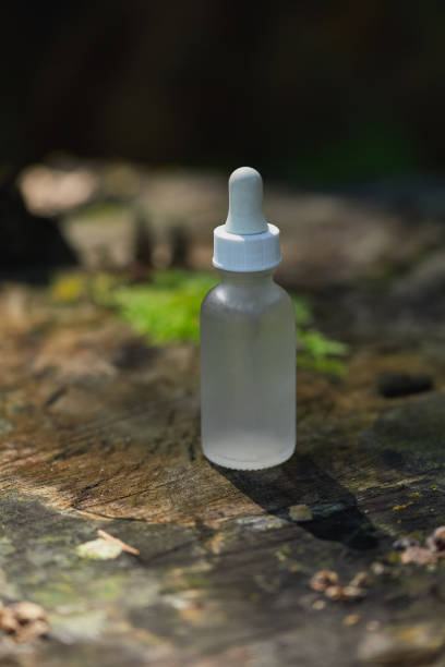 istock Transparent dropper bottle on a wooden surface surrounded by nature 2193976513