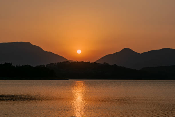 istock Sun over the hills by the lake 2193976689