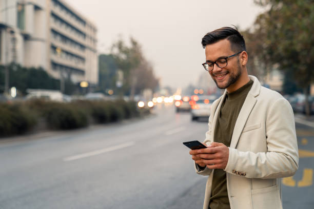 istock Modern Caucasian Professional Using Mobile Application On Downtown City Street 2193977940